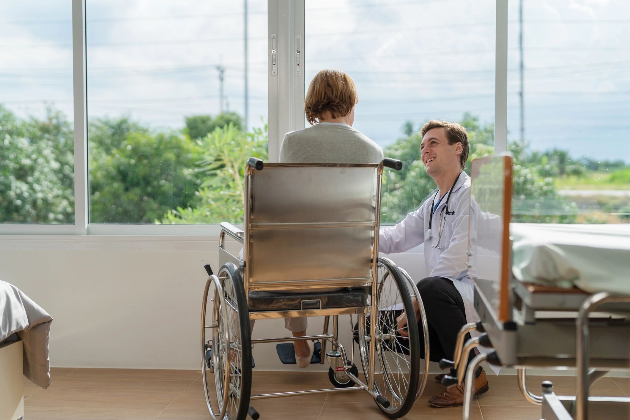 Care professional speaking with a wheelchair user