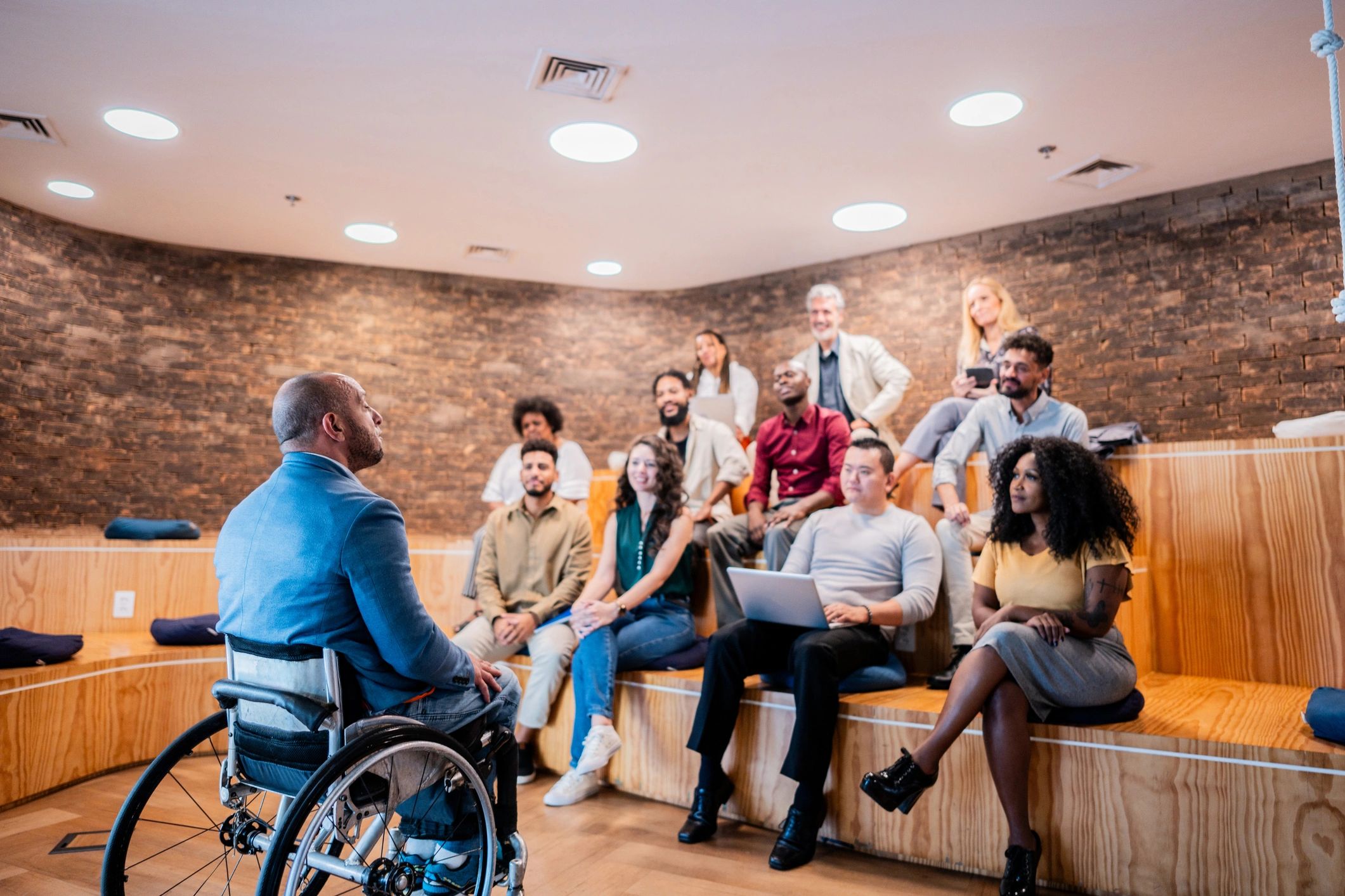 Inclusive workplace team member presenting in an accessible office